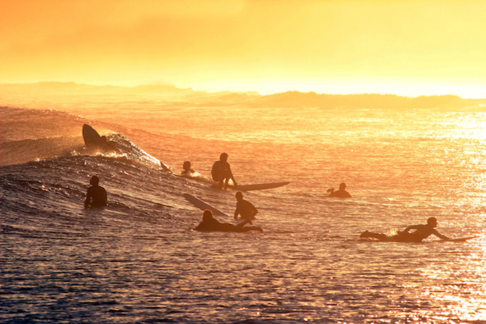 Surfer riding a wave at Playa de Merón beach break in Cantabria